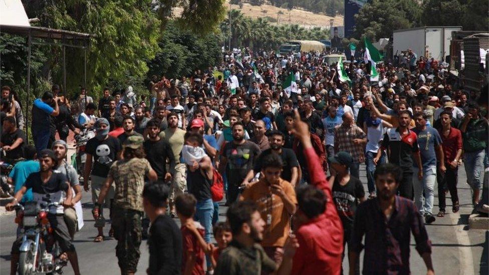 Syrians from the country's northern countryside demonstrate by the Bab al-Hawa crossing between Turkey and Syria's north-western Idlib province