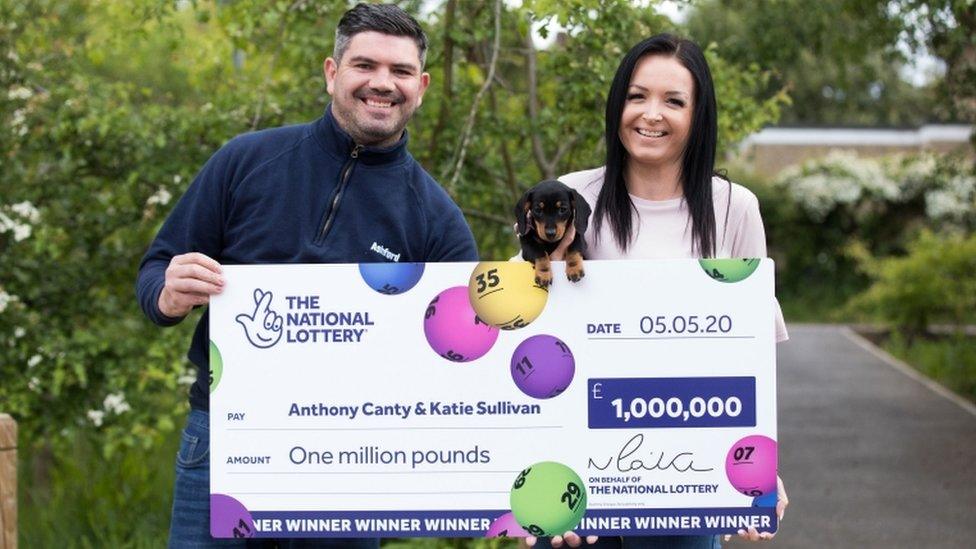 Anthony Canty, Katie Sullivan and Lucky Lola the dachshund with a giant cheque