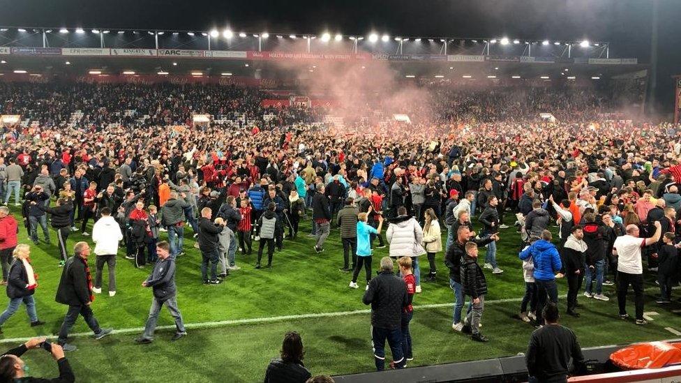 fans on pitch