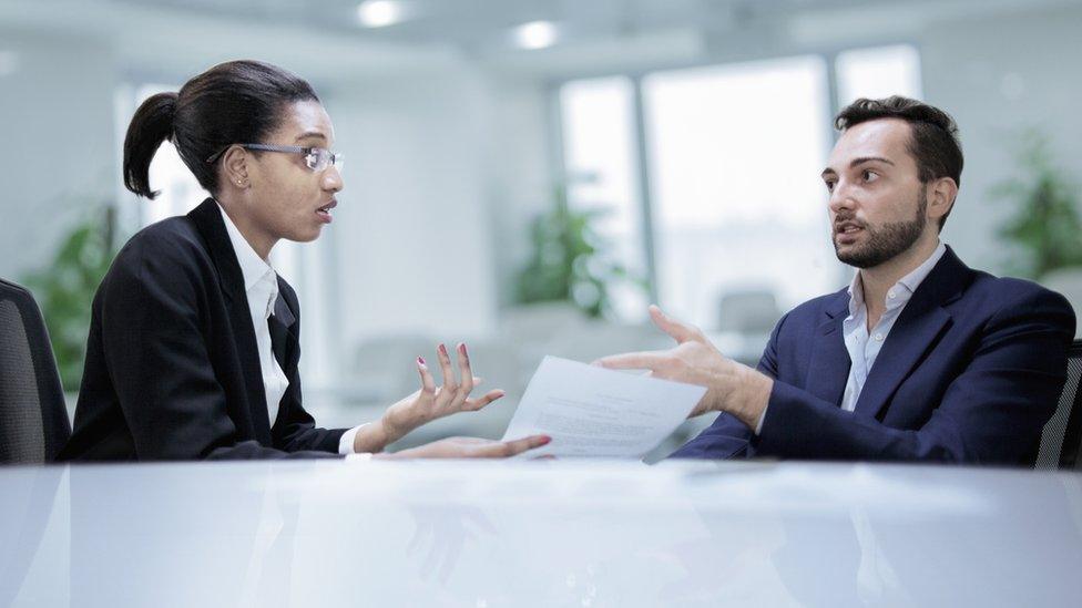 Colleagues working together during discussion in office