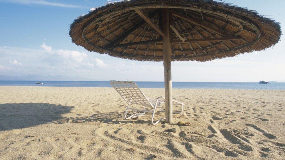 Parasol on a beach on Lake Malawi, Malawi, Africa