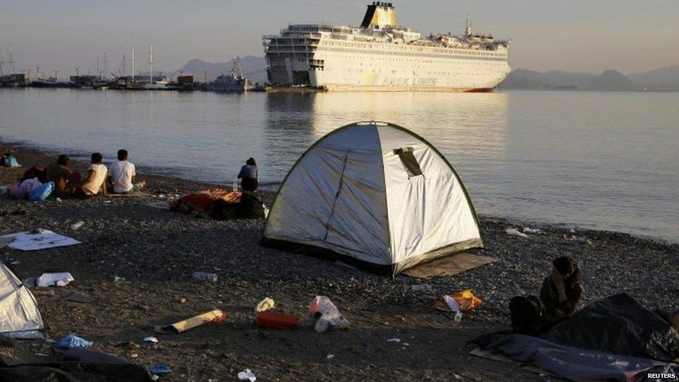 Syrian refugees camp on a Kos beach near the port where the ferry Eleftherios Venizelos is docked 15/08/2015.