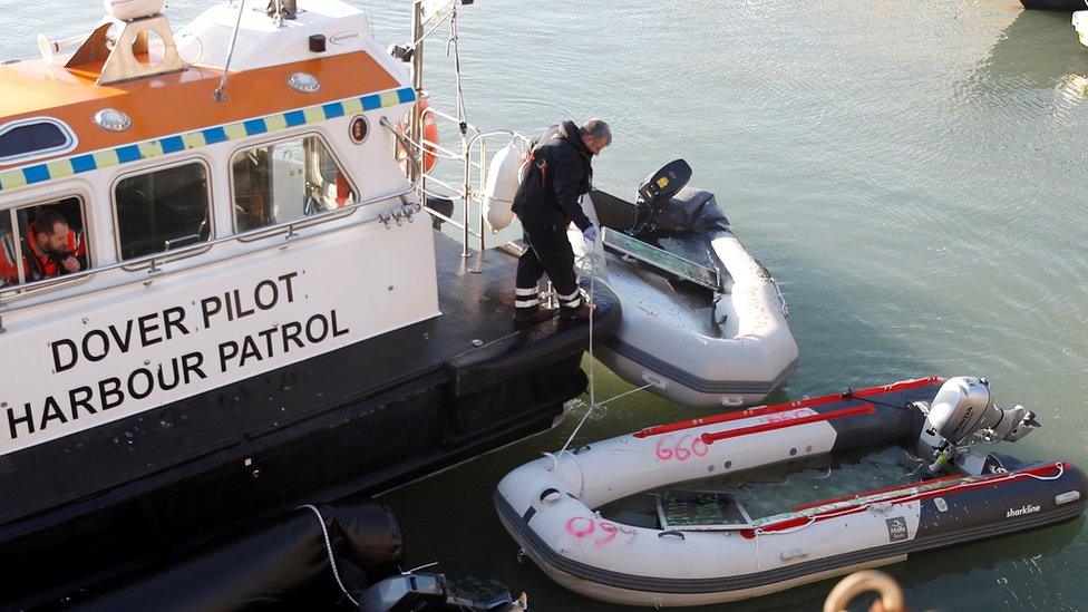 Border patrol takes inflatable boats used by migrants out of the Channel