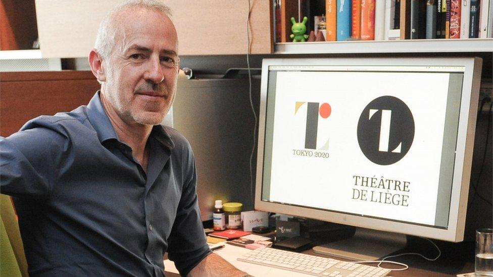 Belgian Designer Olivier Debie poses for a photographer in his office in Liege on July 30, 2015 as his computer display shows Tokyo"s 2020 Olympic emblem (L) and the logo of the Theatre de Liege.