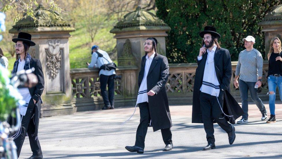 Jewish men walk through Central Parkin New York