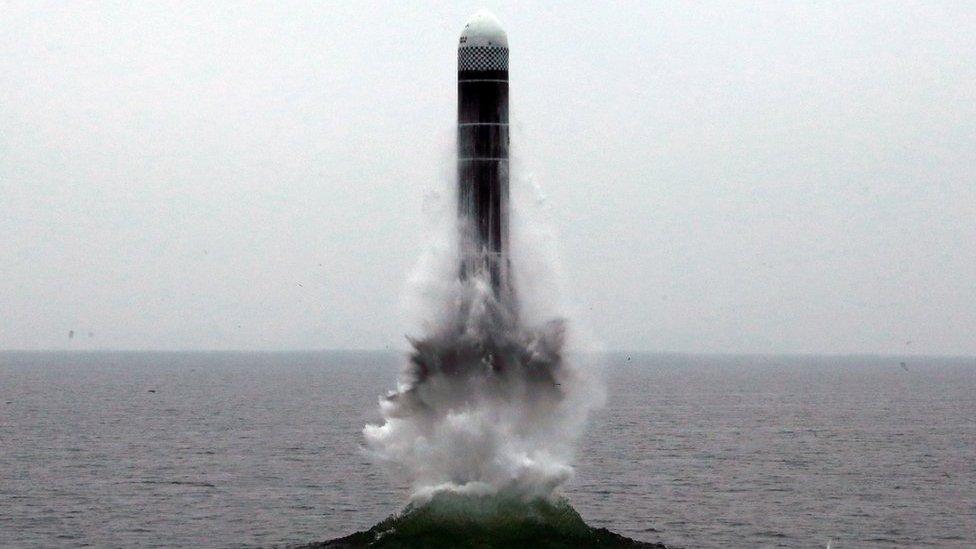 What appears to be a submarine-launched ballistic missile (SLBM) flies in an undisclosed location in this undated picture released by North Korea's official news agency