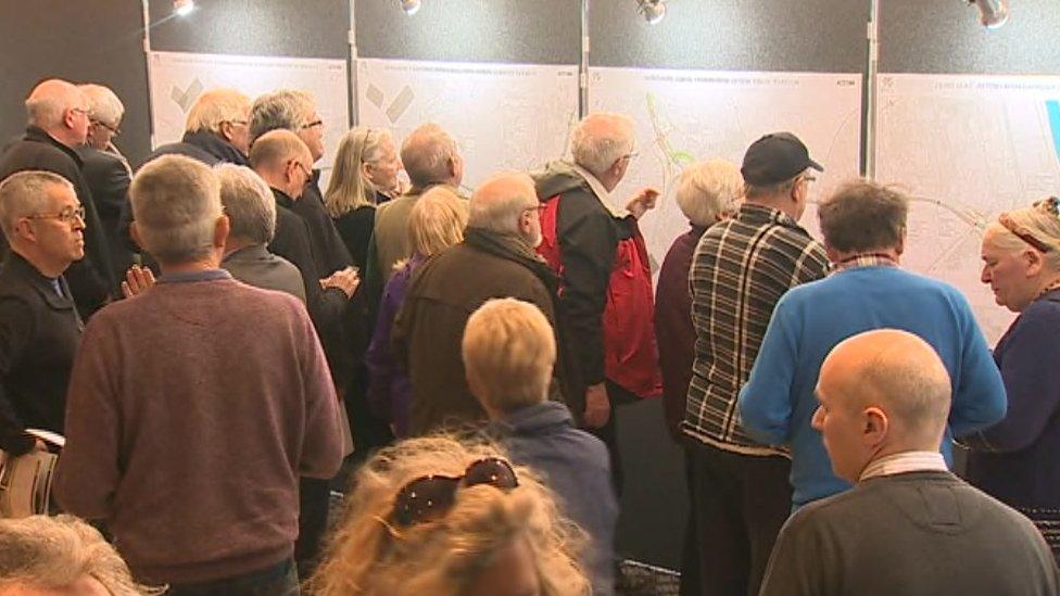 Residents look at the plans on display