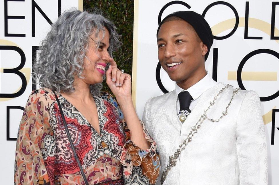 Musician Pharrell Williams (right) and producer Mimi Valdes arrive at the 74th annual Golden Globe Awards