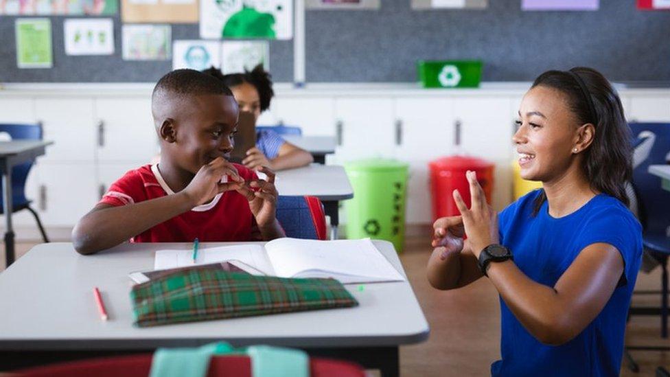 Child being taught BSL in the classroom