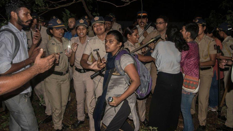 Activists break barricades to stop authorities from cutting at the main gate of Metro car shed , Picnic point, Aarey colony , Goregaon east, on October 5, 2019 in Mumbai.