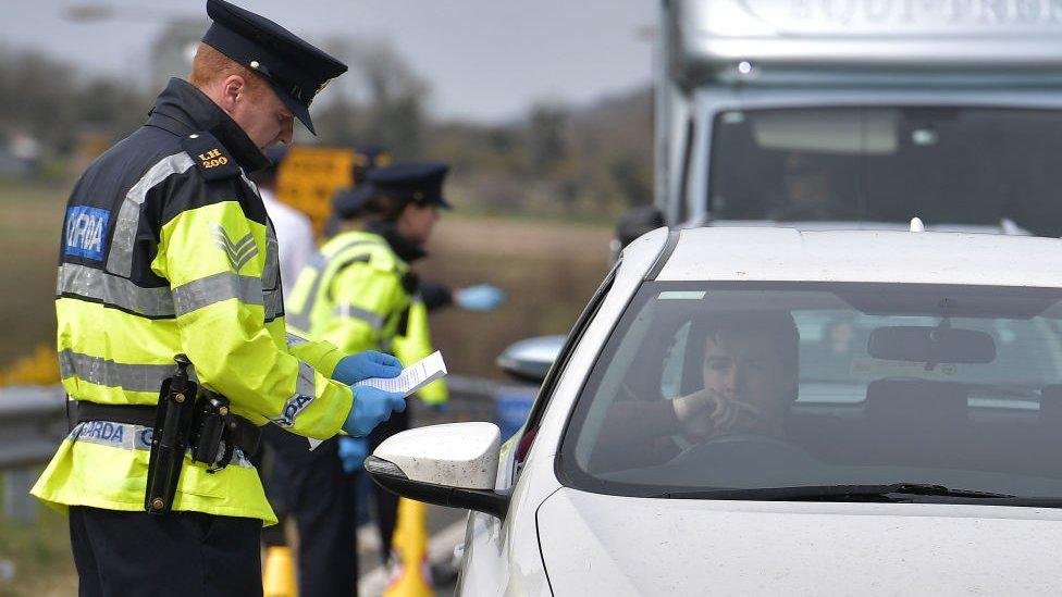 Irish police officers check drivers and cars during the coronavirus outbreak