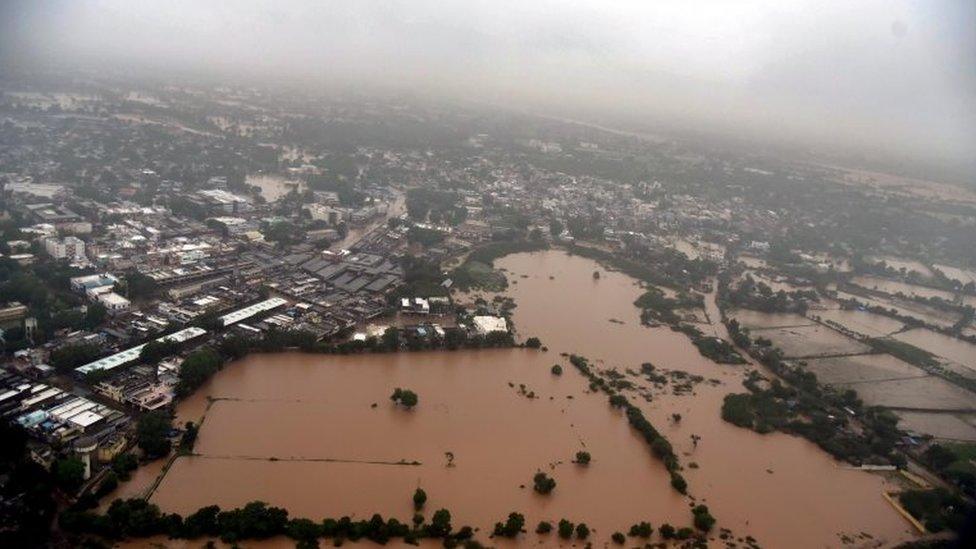 A handout picture from the Gujarat Information Bureau taken and released on July 25, 2017 from an Indian Air Force helicopter shows villages of Banaskantha district, Gujarat state, surrounded by water due to floods.