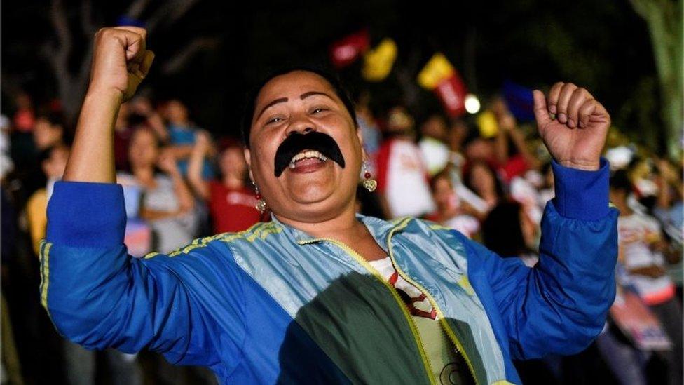 Supporters of the Venezuelan President Nicolas Maduro celebrate after the National Electoral Council (CNE) announced the results of the voting on election day in Venezuela, on May 20, 2018 in Caracas.