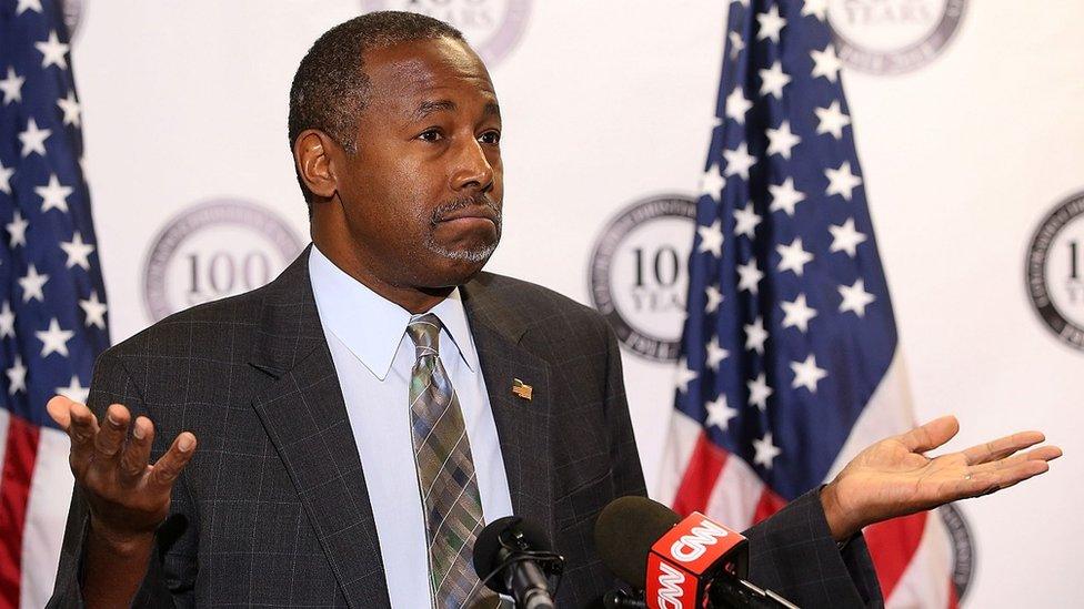 Ben Carson shrugs during a press conference.