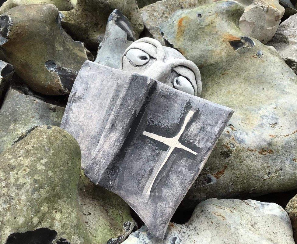 One of the ceramic figures of a Benedictine monk within the walls of the Abbey of St Edmund