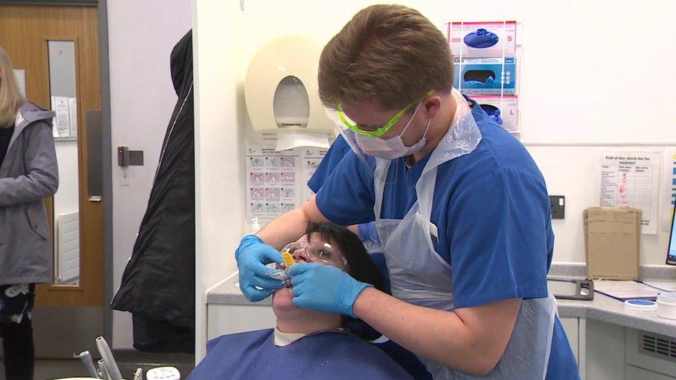 student dentist with patient