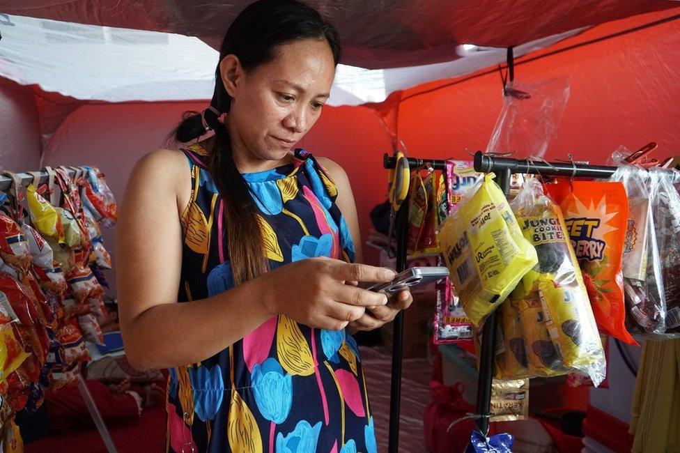 Monet Oxales with her small makeshift grocery story