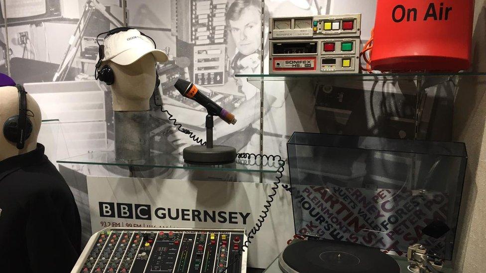 Items in a display case for 40th anniversary of BBC Radio Guernsey