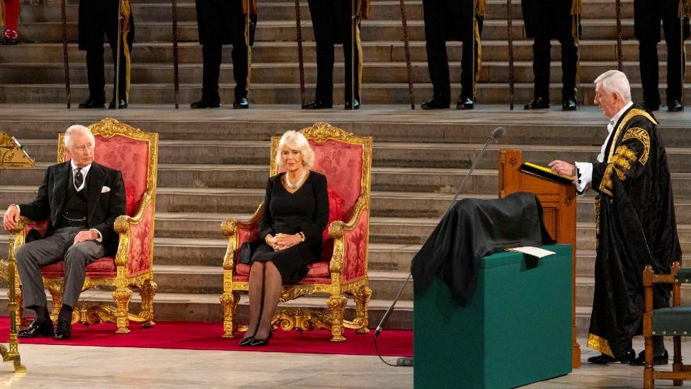 Speaker of the House of Commons Sir Lindsay Hoyle speaks as Britain's King Charles and Queen Camilla sit during the presentation of addresses by both Houses of Parliament