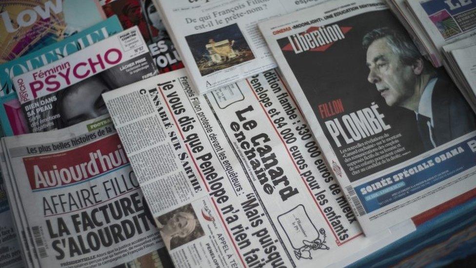 An issue of French satirical weekly newspaper Le Canard Enchaine on display among other newspapers in a kiosk in Paris (01 February 2017)