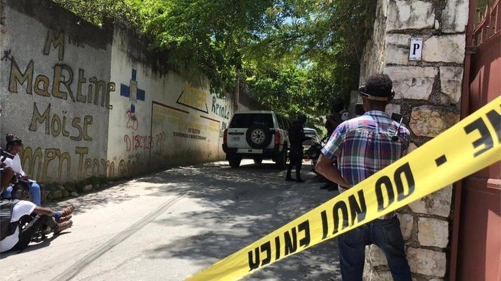 Journalists stand next to a yellow police cordon near the residence of Haiti's President Jovenel Moise after he was shot dead by unidentified attackers, in Port-au-Prince, Haiti July 7, 2021.