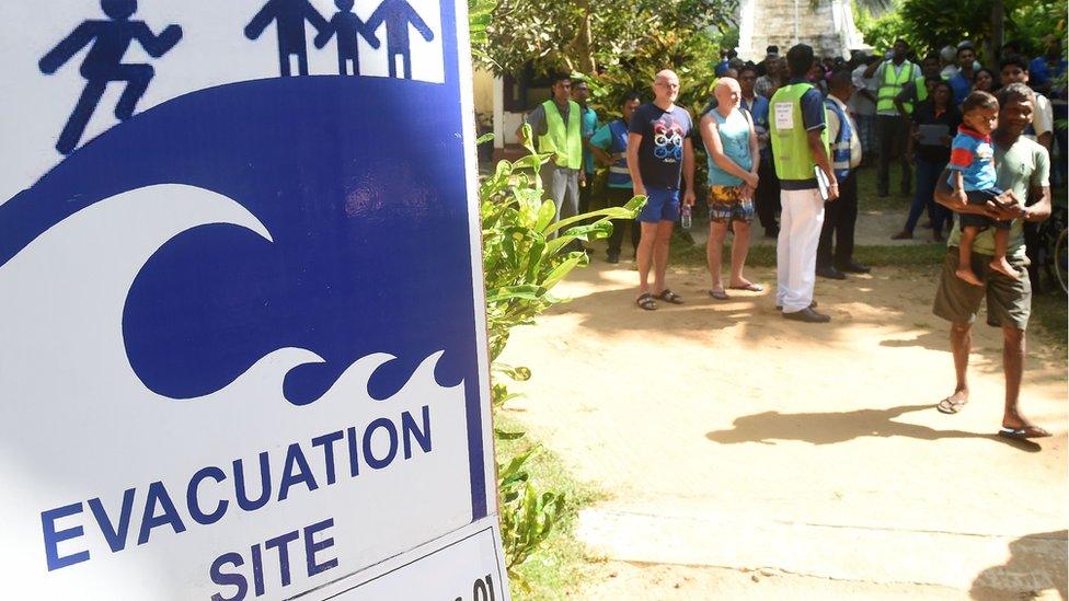 Tourists take part in a tsunami evacuation drill in Hikkaduwa on September 5, 2018