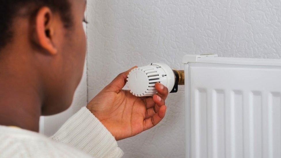 Woman adjusting a radiator