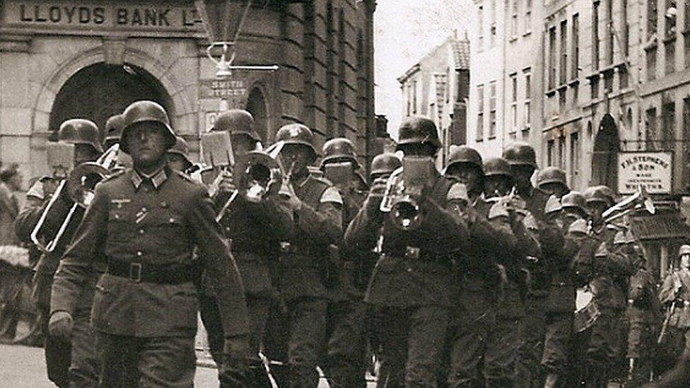 A German band marches through Guernsey's St Peter Port High Street