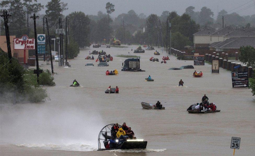 Residents use boats to evacuate flood waters from Tropical Storm Harvey along Tidwell Road east Houston, Texas, U.S. August 28, 2017