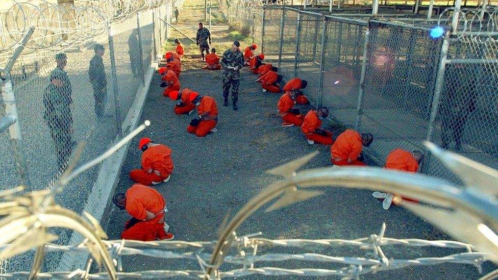 Taliban and al Qaeda detainees in a holding area at Camp X-Ray at Guantanamo Bay in January 2002