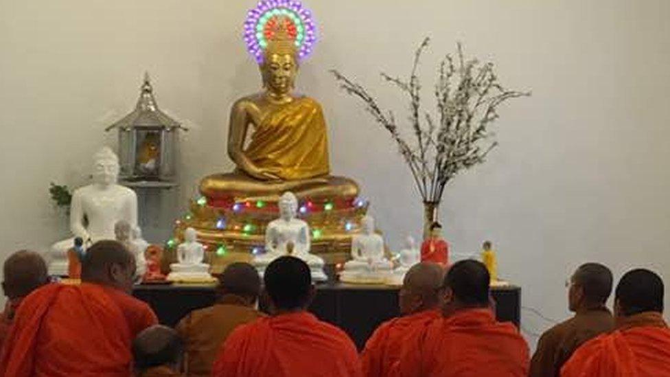 Buddhists in front of the stolen statue in Botswana's capital, Gaborone