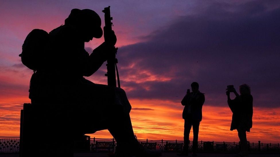 People walk past the Tommy statue, officially named 1101, on Terrace Green by the seafront in Seaham, County Durham