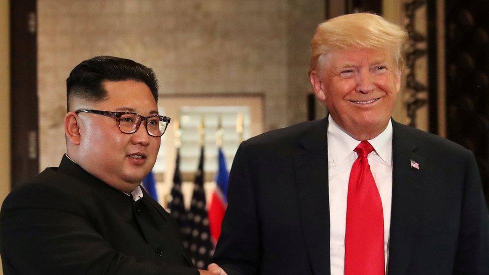 President Donald Trump and North Korea's leader Kim Jong Un shake hands after signing documents during a summit in Singapore