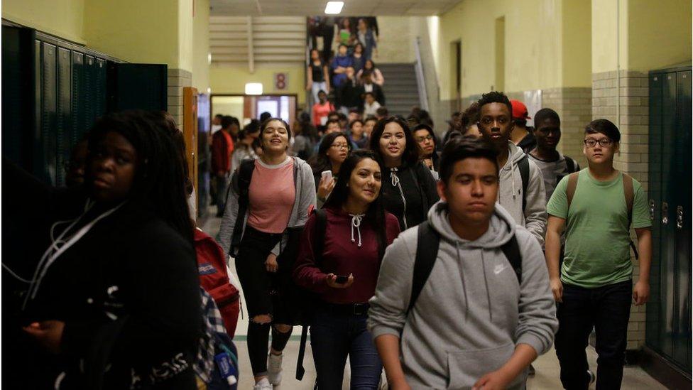 Students walk through the hallway after classes were dismissed at Senn High School on Wednesday, May 10, 2017 in Chicago, Illinois