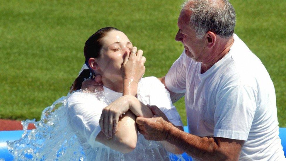 A young woman from the Jehovah's Witnesses is baptised on 20 July 2003 in Prague