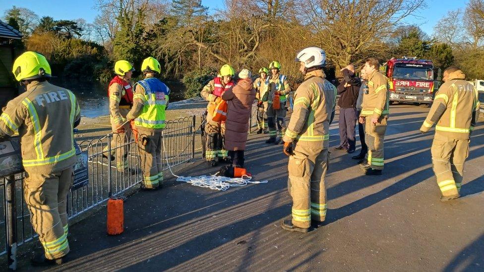 Ponzo is reunited with her owner while firefighters look on