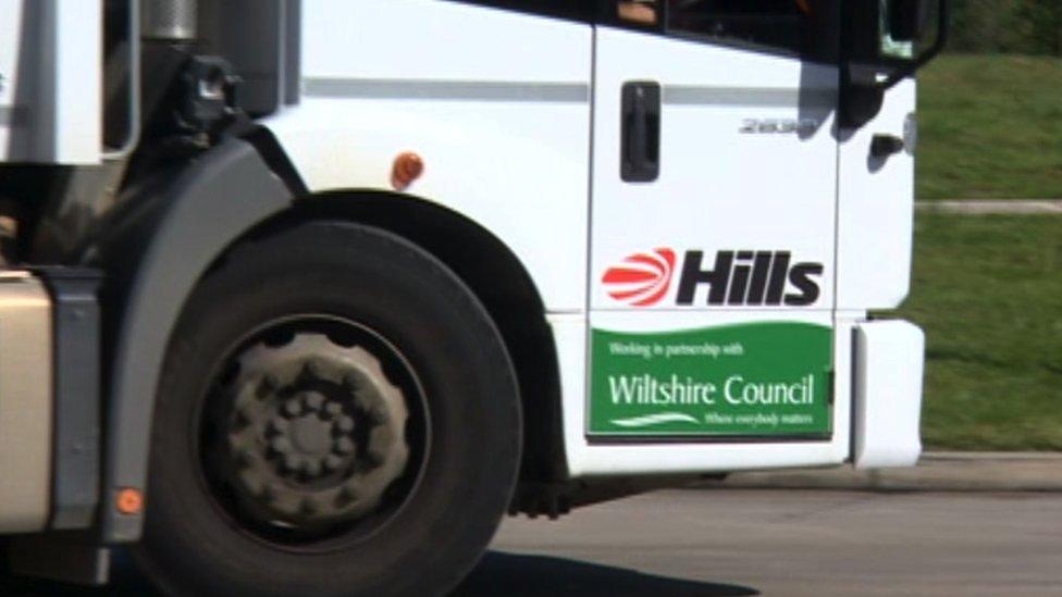 A refuse truck with Hills branding and Wiltshire Council partnership logo