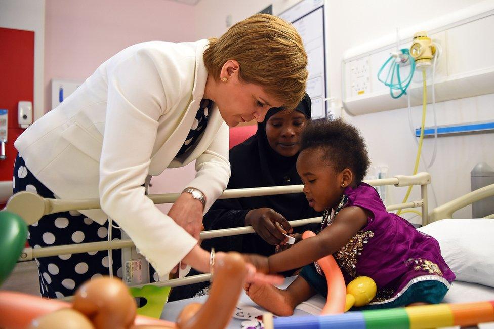 Scotland's First Minister Nicola Sturgeon meets a patient at the Royal Hospital for Children in Glasgow