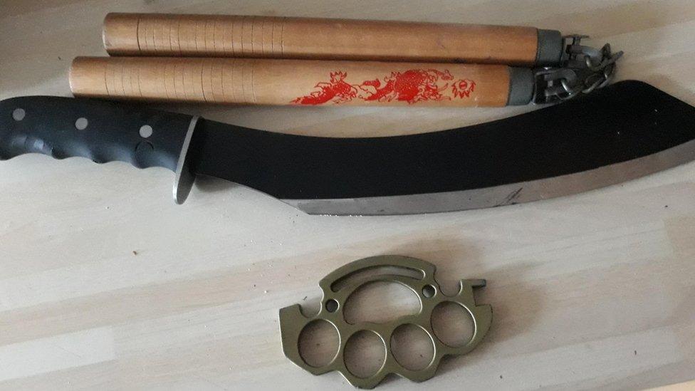 A knuckleduster, nunchuk and machete