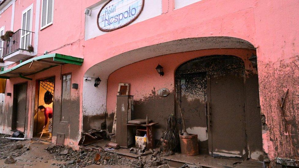 A hotel covered in mud stains suggests the landslide had considerable height