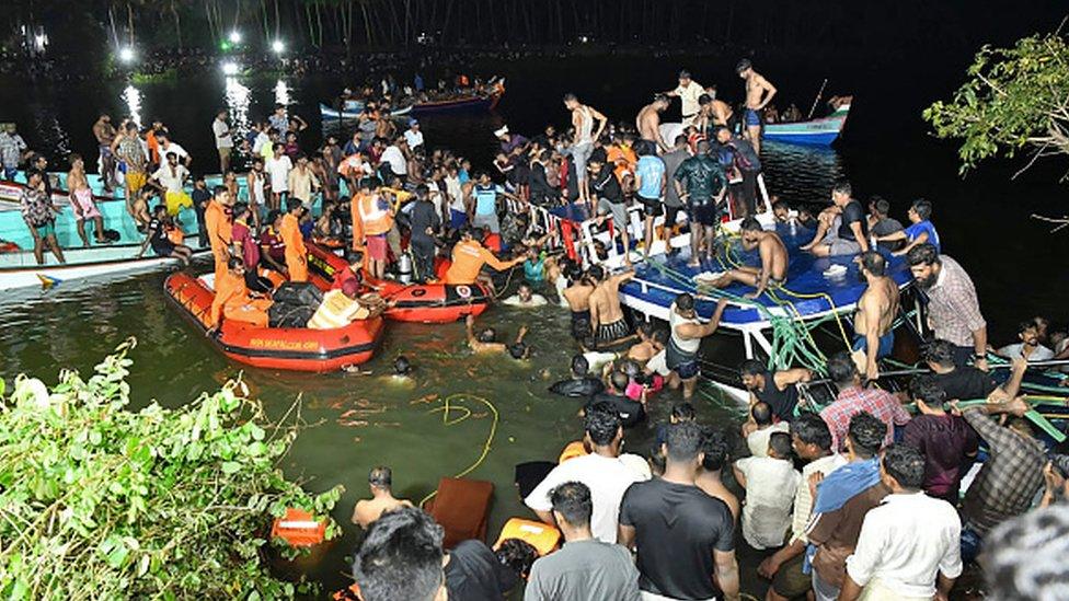 In this photograph taken on May 7, 2023, people carry out rescue operation at the site of a boat accident in Tanur