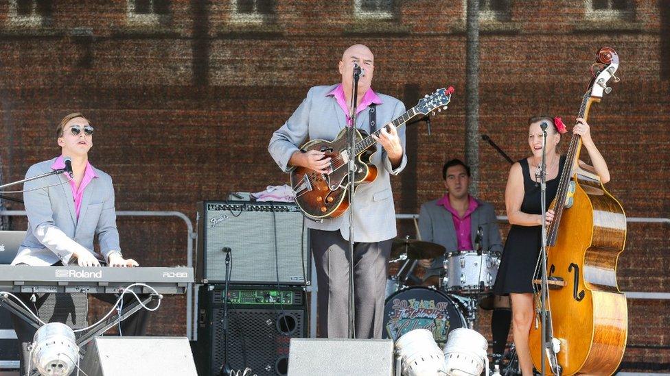 A band performing on the Main Stage in Mariners Square during Gloucester Goes Retro 2022