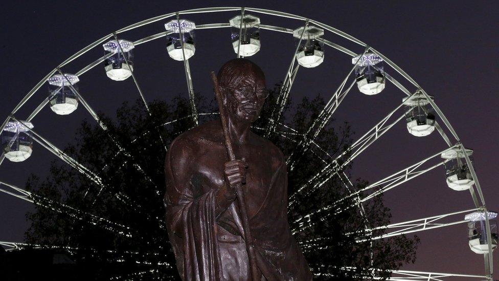 A statue of Mahatma Gandhi is seen in front of the Wheel of Light before the switching on of Diwali lights in Leicester