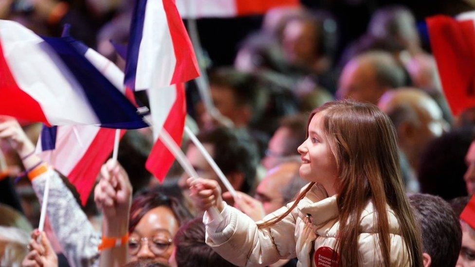 Supporters of founder and Leader of the political movement 'En Marche !' Emmanuel Macron celebrates after winning the lead percentage of votes in the first round of the French Presidential Elections at Parc des Expositions Porte de Versailles on April 23, 2017 in Paris, France.