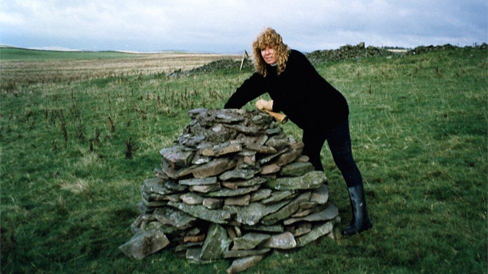 Suse Lowenstein with the cairn she built to remember her son