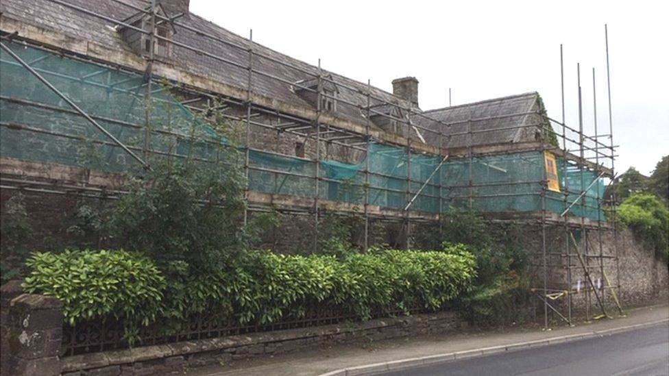 Scaffolding surrounds the frontage of the building