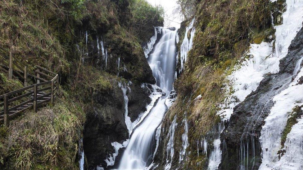 An icy waterfall cascades down the glens of Antrim in Glenariff forest park