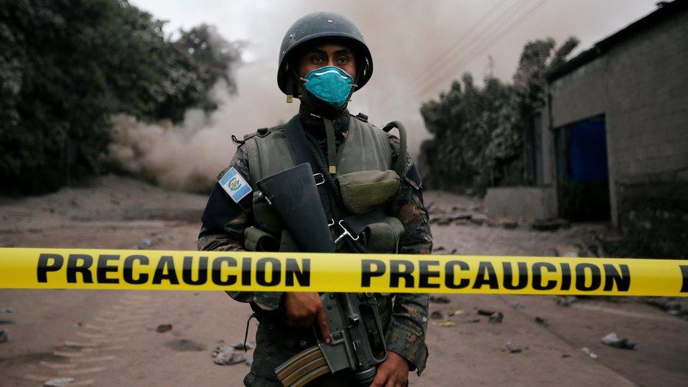 A soldier keeps watch at a restricted area affected by an eruption from Fuego volcano in the community of San Miguel Los Lotes in Escuintla, Guatemala, June 4, 2018