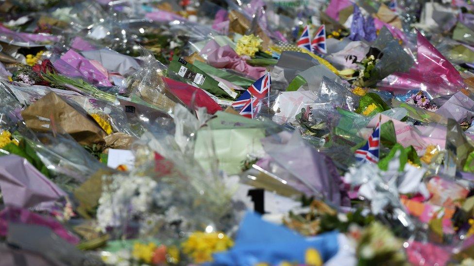 Flowers lie outside Westminster Palace in London