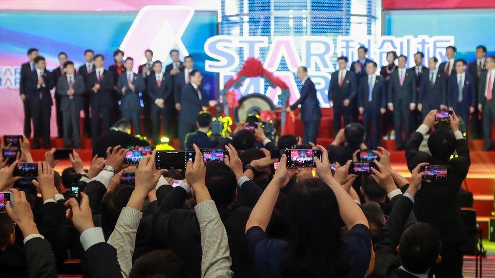 People take pictures during an opening ceremony of the Shanghai Stock Exchange's Sci-Tech Innovation Board in Shanghai on July 22, 2019